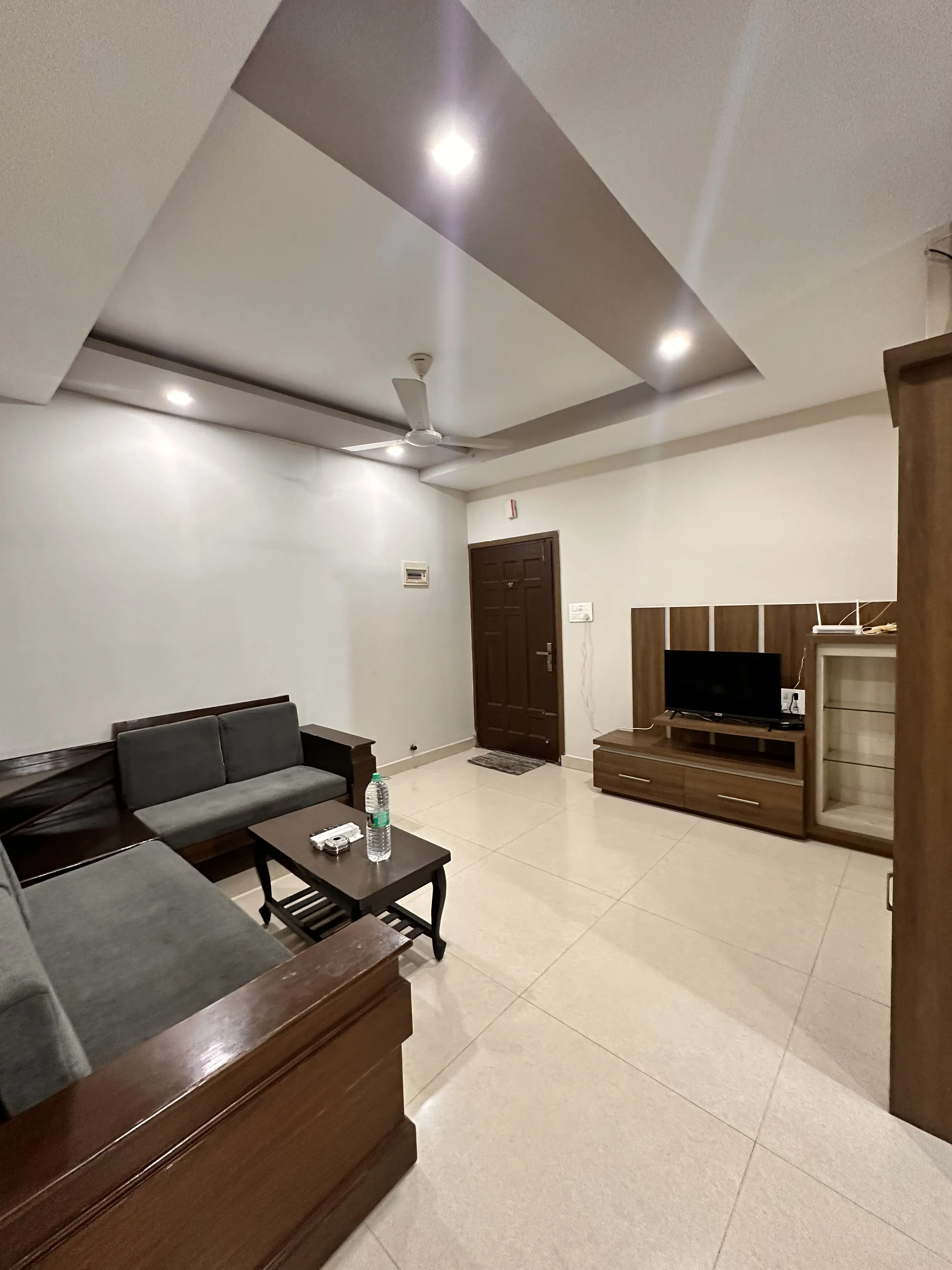 Modern living with dark wood sectional sofa and media console